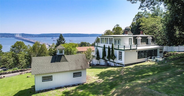 71 Old Mountain Rd S, Nyack, NY 10960 - rear view of property featuring a chimney, a water view, a lawn, an outdoor structure, and a shingled roof