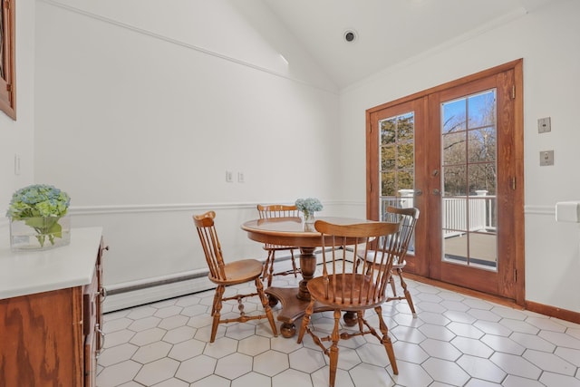 dining room featuring baseboards, vaulted ceiling, french doors, baseboard heating, and ornamental molding