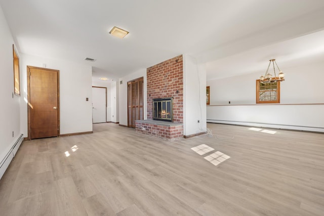 unfurnished living room with a baseboard radiator, visible vents, a baseboard heating unit, a brick fireplace, and wood finished floors