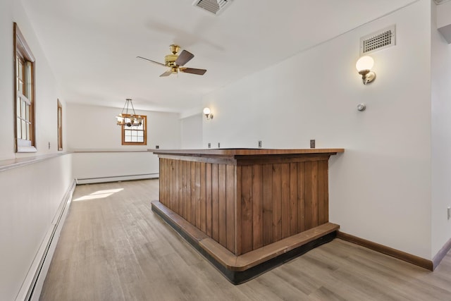 bar featuring a baseboard heating unit, light wood-style flooring, a baseboard radiator, and visible vents