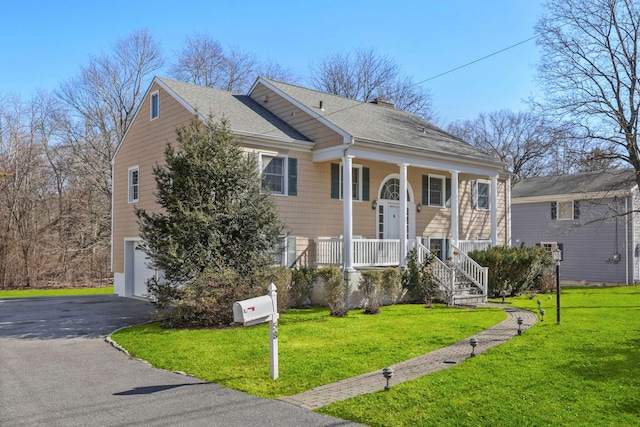 bi-level home featuring aphalt driveway, an attached garage, covered porch, a shingled roof, and a front lawn