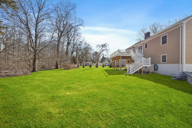 view of yard with stairs and a wooden deck