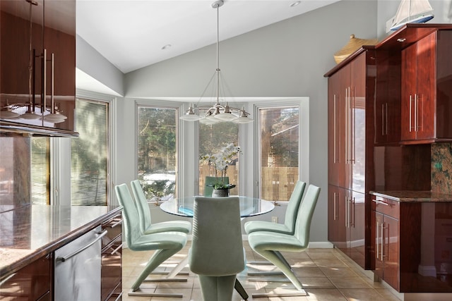 dining room with lofted ceiling and light tile patterned floors