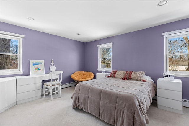 bedroom with a baseboard heating unit, a baseboard radiator, light colored carpet, and recessed lighting