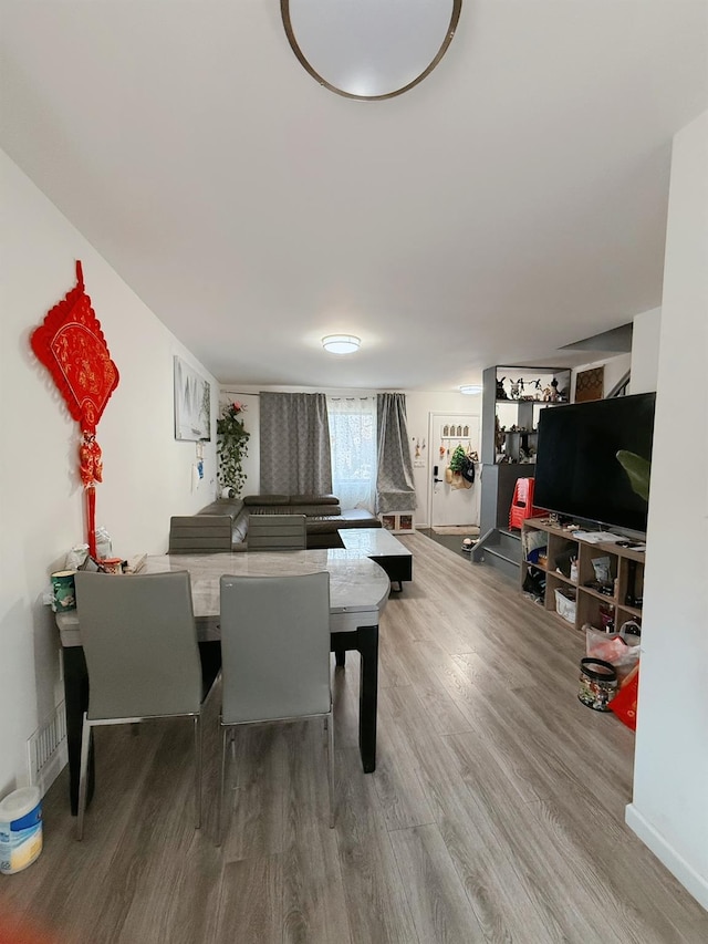 dining area with wood finished floors