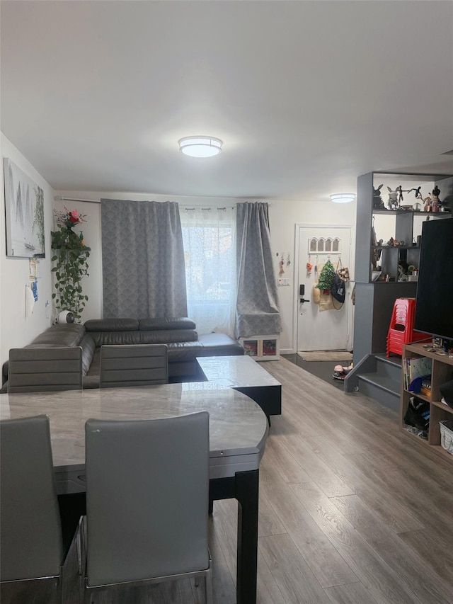 dining space with wood finished floors