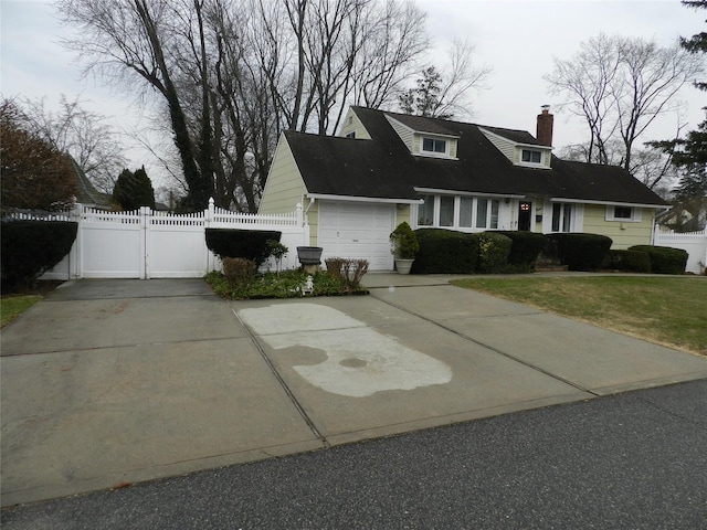 view of front of home featuring driveway, a chimney, an attached garage, a gate, and fence