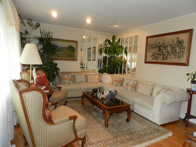 living room with ornamental molding and wood finished floors