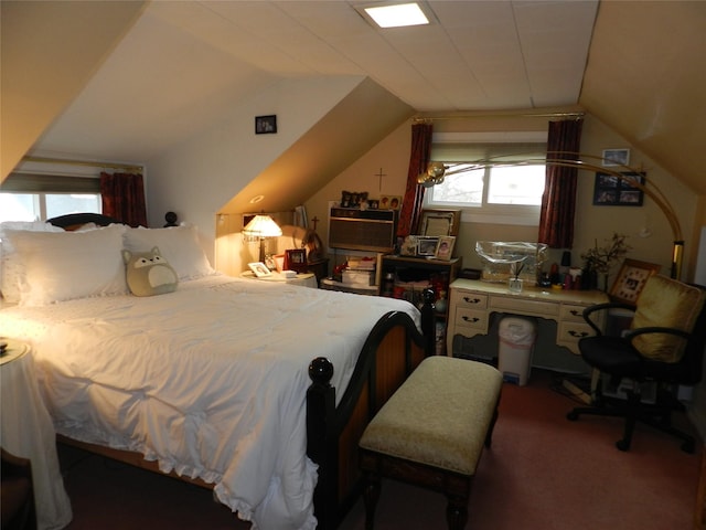 bedroom featuring lofted ceiling and carpet