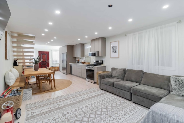 living room with recessed lighting and light wood-style floors