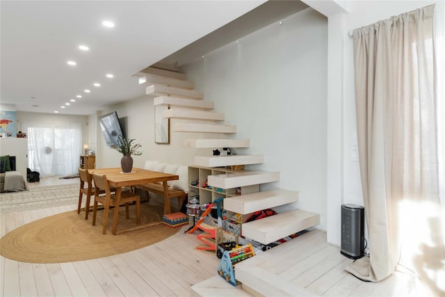 stairs featuring recessed lighting and wood finished floors