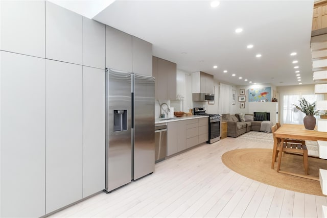 kitchen featuring appliances with stainless steel finishes, gray cabinetry, and modern cabinets