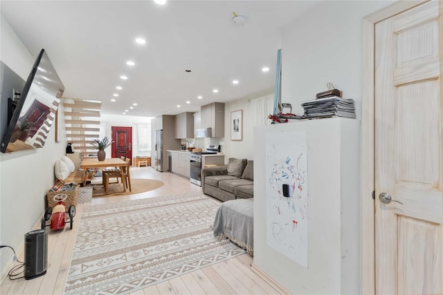 living room featuring light wood-style flooring and recessed lighting