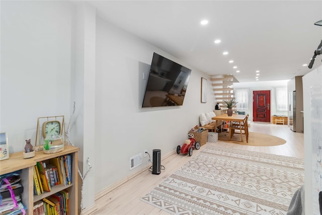 interior space with wood finished floors, visible vents, and recessed lighting