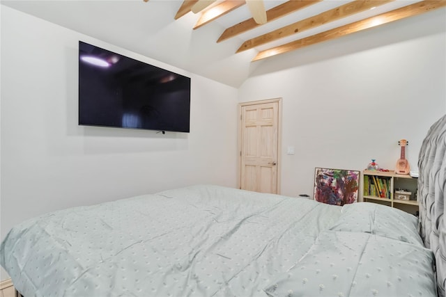 bedroom featuring lofted ceiling with beams