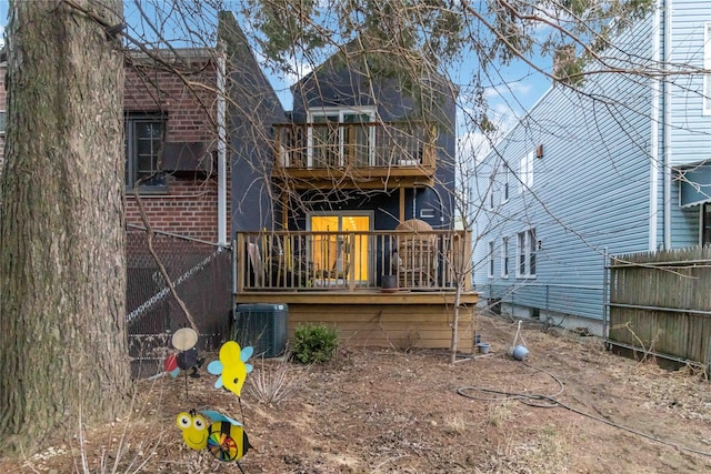 back of property featuring central AC, brick siding, fence, and a balcony