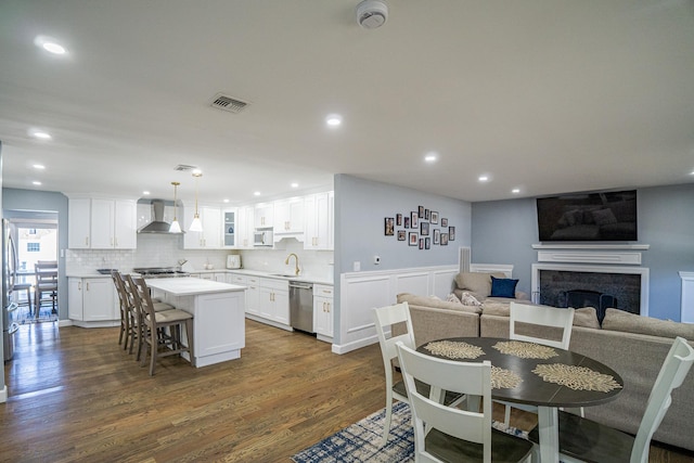 dining room with recessed lighting, dark wood-style flooring, visible vents, and a fireplace