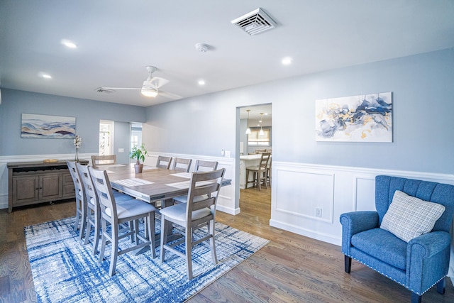 dining space featuring visible vents, a ceiling fan, wainscoting, wood finished floors, and recessed lighting