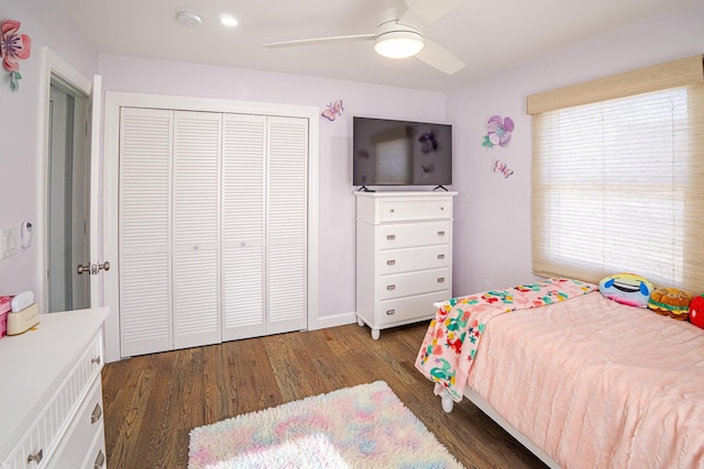 bedroom with a closet, multiple windows, ceiling fan, and wood finished floors