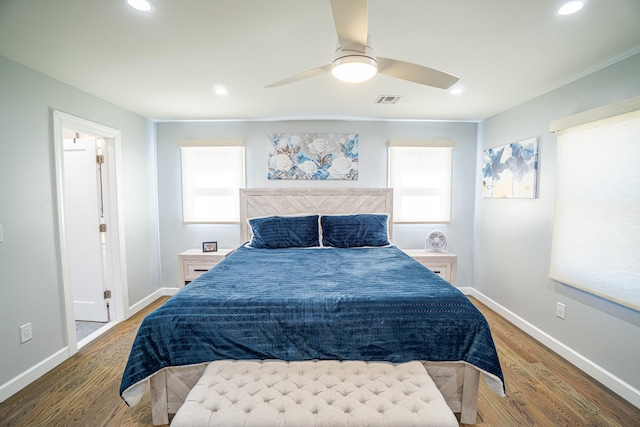 bedroom with visible vents, baseboards, wood finished floors, and recessed lighting