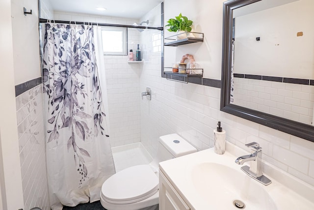 full bath with a stall shower, tile walls, toilet, and vanity