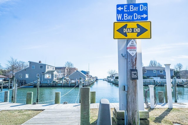 view of dock featuring a residential view and a water view