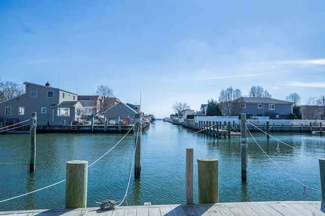 view of dock featuring a water view and a residential view