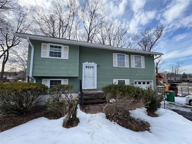 split foyer home featuring fence