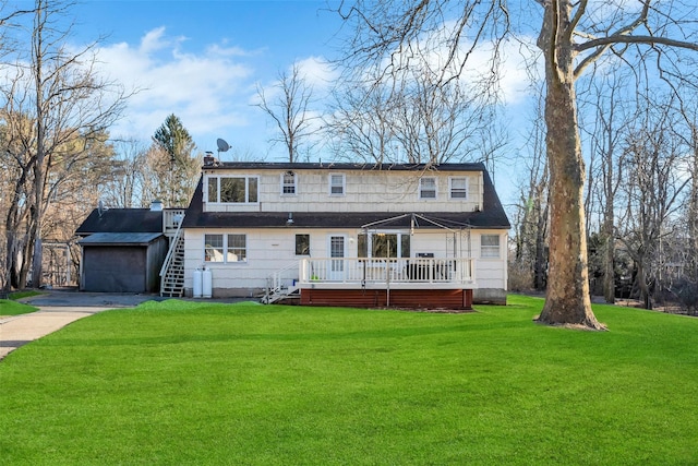 view of front of property with a deck, stairs, driveway, a chimney, and a front yard