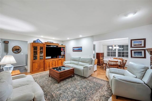 living area featuring a chandelier, recessed lighting, and light wood-style flooring