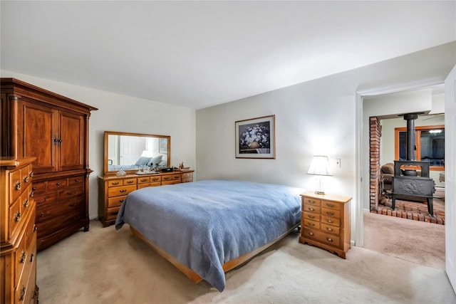 bedroom featuring a wood stove and light carpet