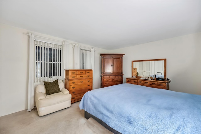 bedroom featuring light carpet