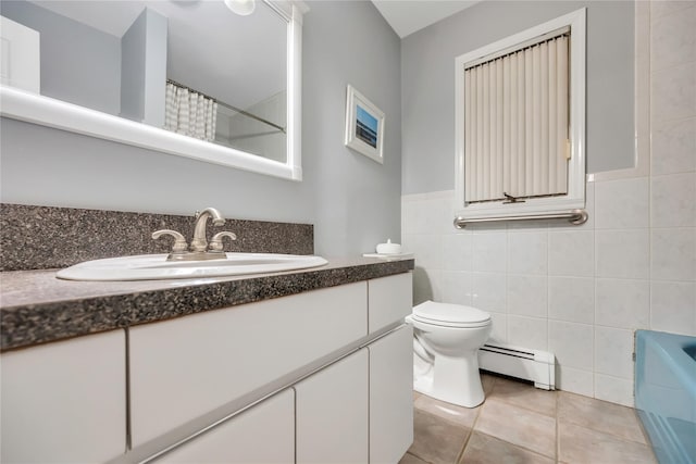 full bathroom featuring a baseboard radiator, toilet, vanity, tile walls, and tile patterned floors