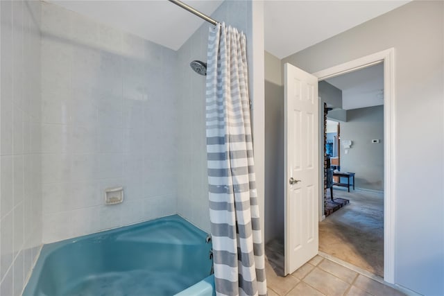 full bathroom featuring tile patterned flooring and shower / tub combo with curtain