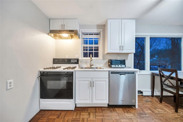 kitchen featuring white gas stove, under cabinet range hood, a sink, white cabinetry, and dishwasher