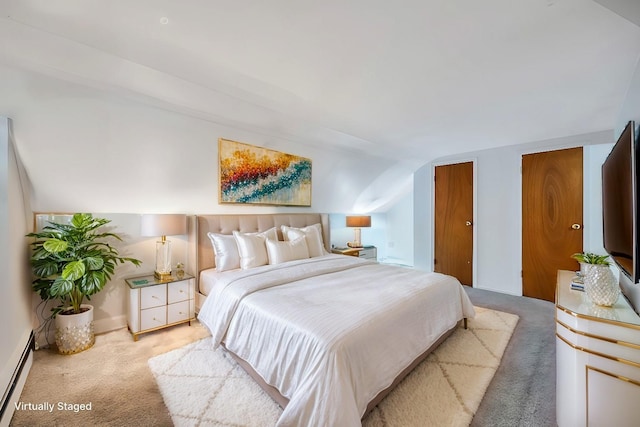 bedroom with carpet floors, a baseboard radiator, two closets, and lofted ceiling