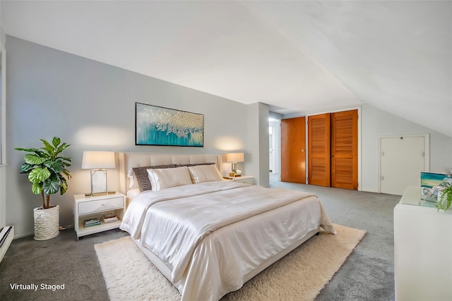 bedroom featuring lofted ceiling, dark carpet, and a closet