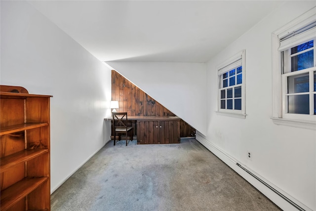 unfurnished office featuring a baseboard heating unit and light colored carpet