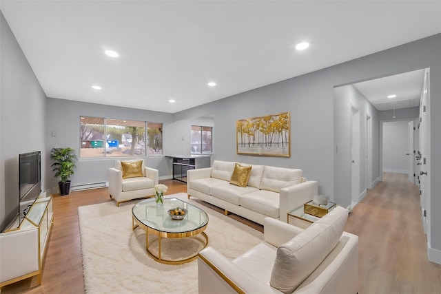 living area with attic access, recessed lighting, a baseboard heating unit, and light wood-style flooring