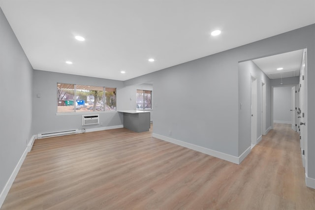 unfurnished living room with a baseboard radiator, recessed lighting, baseboards, light wood-type flooring, and attic access