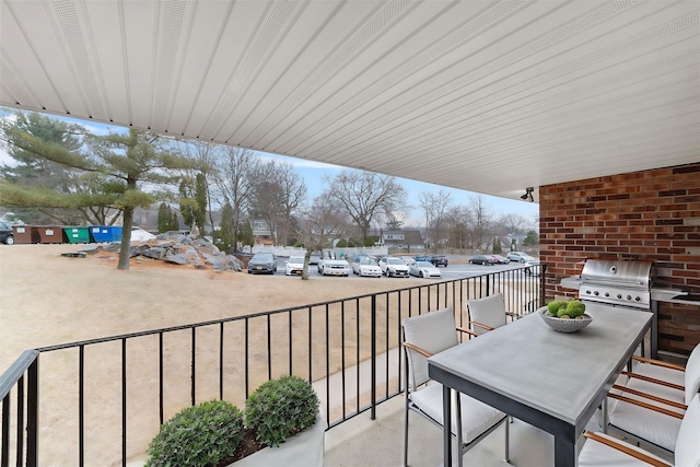 balcony with outdoor dining space and a grill