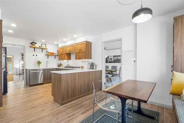 kitchen featuring a peninsula, light wood-style flooring, open shelves, stainless steel appliances, and light countertops