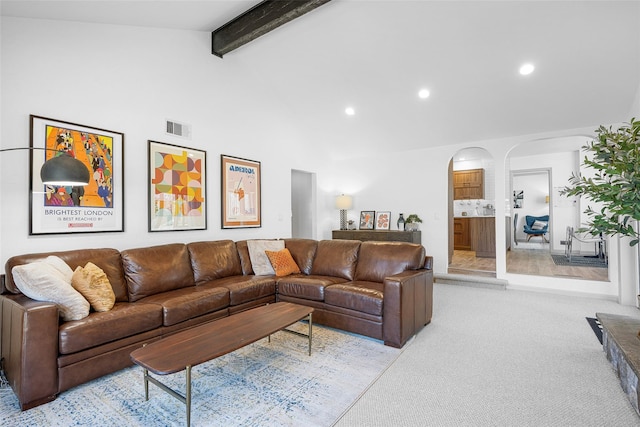 living room featuring visible vents, recessed lighting, arched walkways, beamed ceiling, and light colored carpet