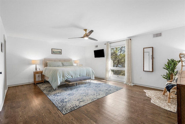 bedroom with ceiling fan, visible vents, baseboards, and wood finished floors