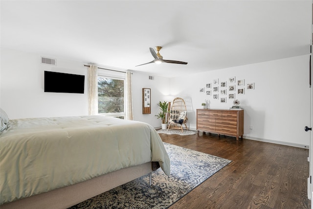 bedroom featuring a ceiling fan, wood finished floors, visible vents, and baseboards