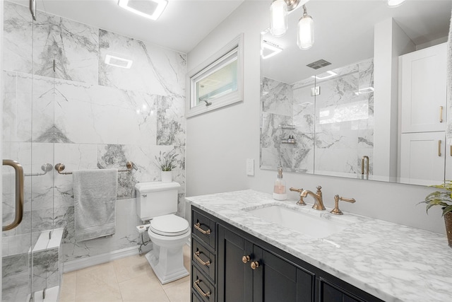 full bath featuring a marble finish shower, toilet, and vanity