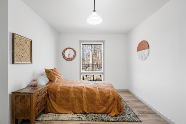 bedroom featuring light wood-style flooring and baseboards