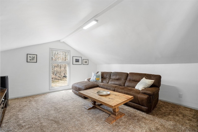 carpeted living area with baseboards and vaulted ceiling with beams