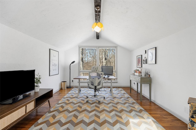 office area with vaulted ceiling with beams, wood finished floors, baseboards, and a textured ceiling