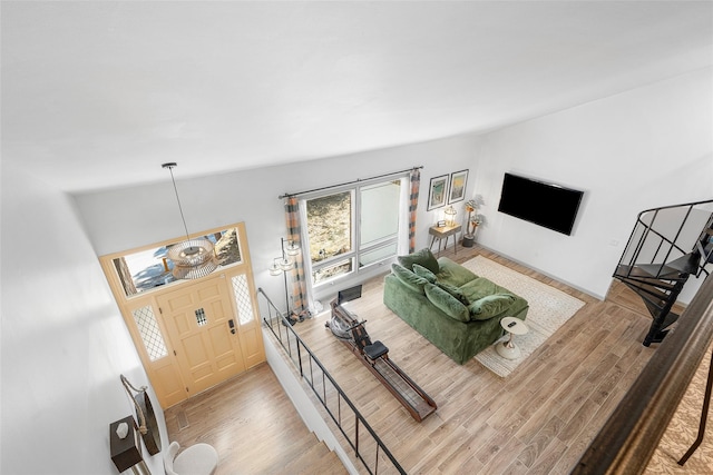 living room with lofted ceiling and wood finished floors